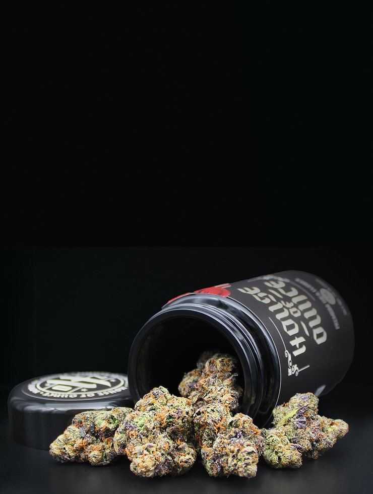 House of Ounce jar and sealed lid on a red silk backdrop